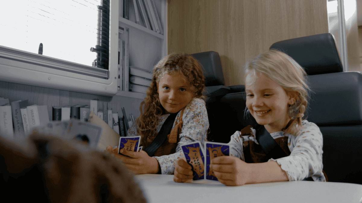 2 girls playing uno cards in Star RV Polaris 6